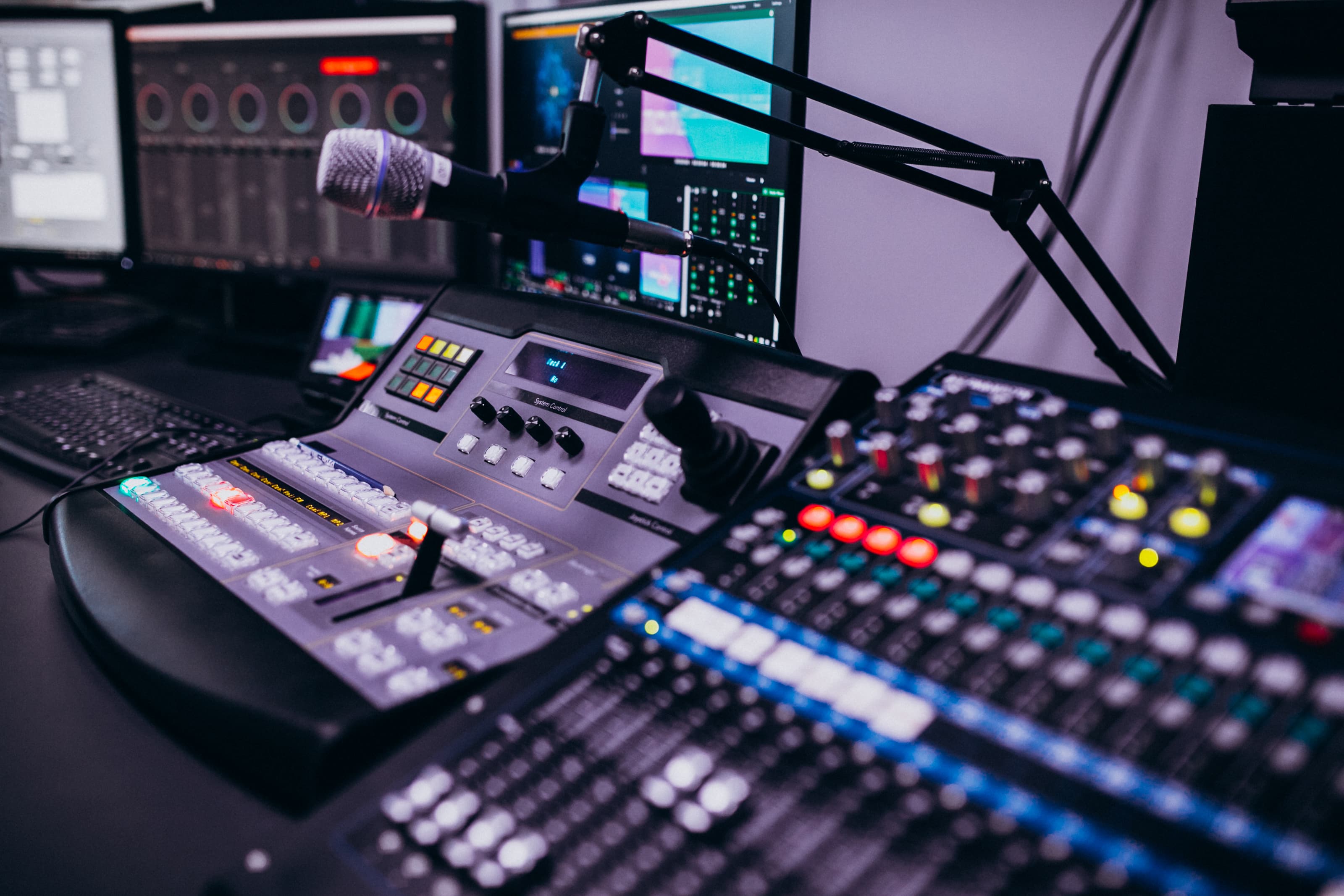 Broadcast studio with a mixing console, monitors, and production equipment