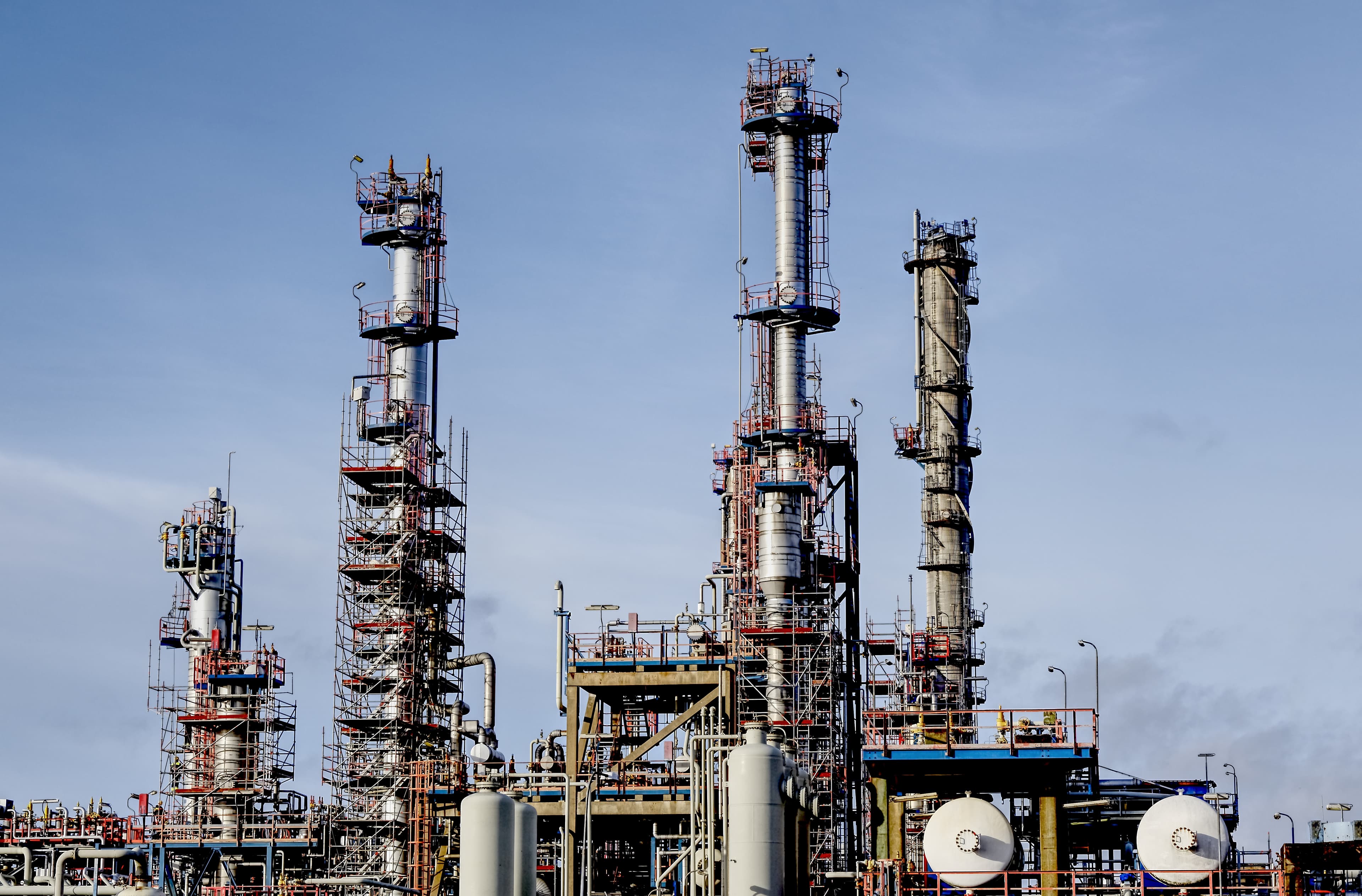 Oil and gas refinery with processing towers and industrial pipework
